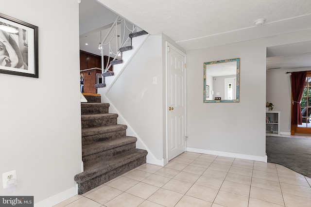 staircase featuring tile patterned floors