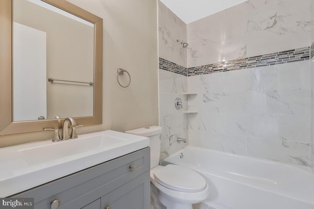 full bathroom with vanity, tiled shower / bath combo, and toilet