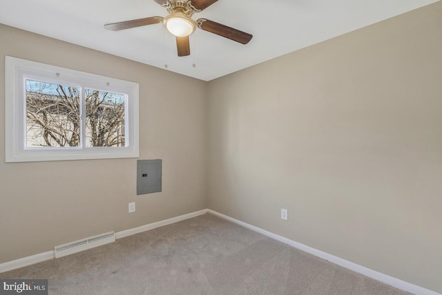 carpeted spare room featuring ceiling fan and electric panel