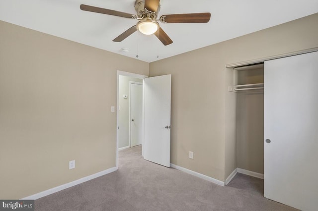 unfurnished bedroom with ceiling fan, light carpet, and a closet