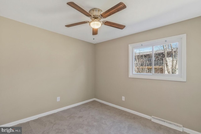 spare room featuring light carpet and ceiling fan