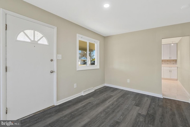 entrance foyer with dark wood-type flooring and a wealth of natural light