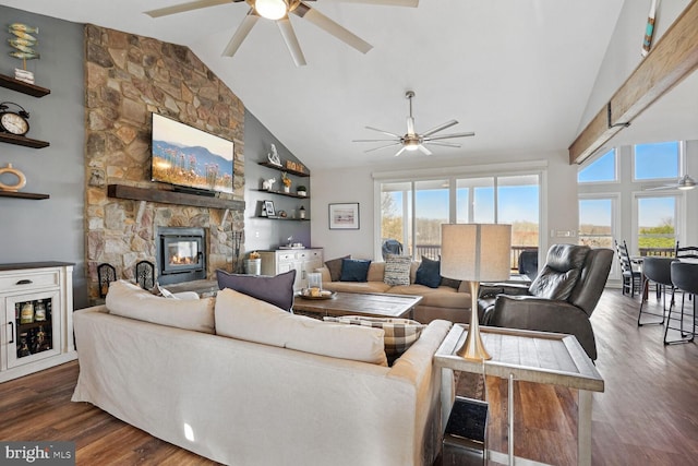 living room featuring dark hardwood / wood-style flooring, lofted ceiling, ceiling fan, and a fireplace