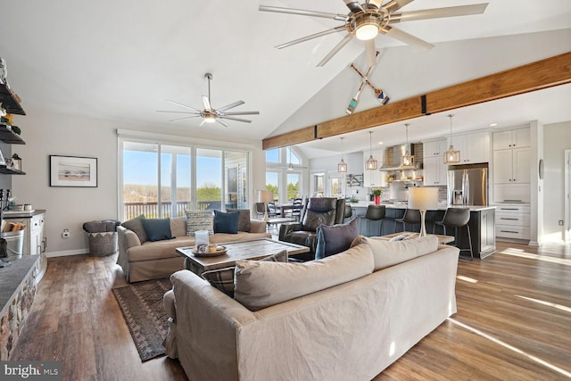 living room with hardwood / wood-style floors, vaulted ceiling with beams, and ceiling fan