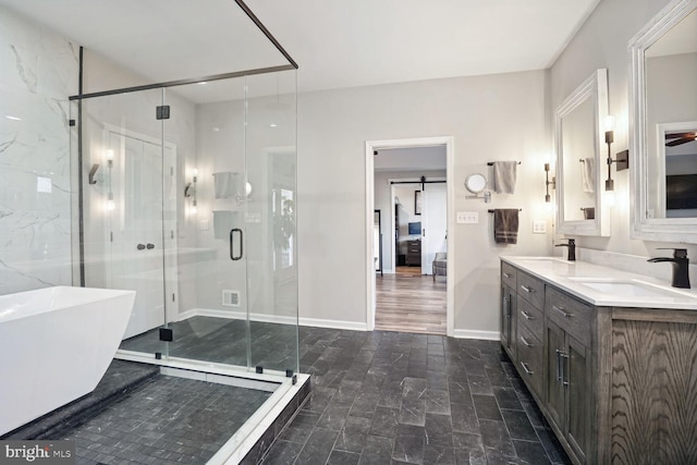 bathroom featuring vanity and separate shower and tub