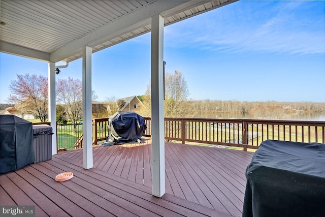 deck featuring grilling area and a water view