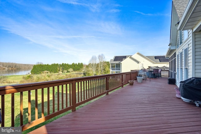 deck with a water view and a grill