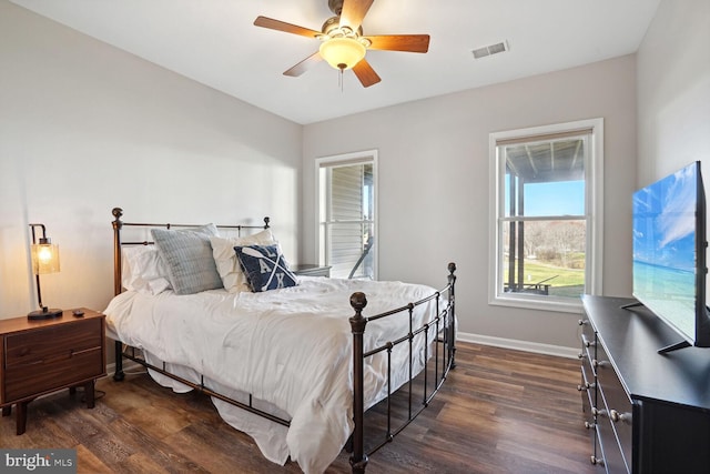 bedroom with dark hardwood / wood-style floors and ceiling fan