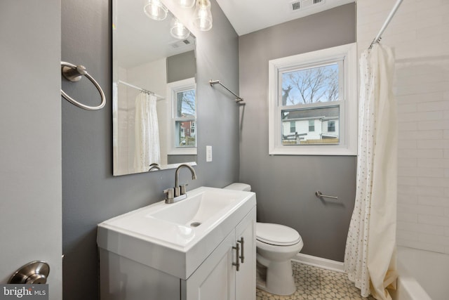 full bathroom with toilet, vanity, a wealth of natural light, and shower / bath combo with shower curtain