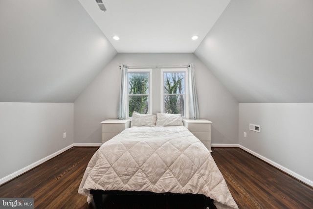 bedroom with vaulted ceiling and dark wood-type flooring