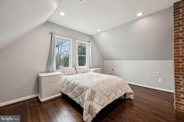 bedroom with dark hardwood / wood-style flooring and lofted ceiling