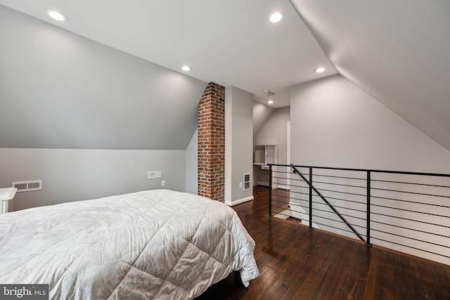 bedroom with lofted ceiling and dark hardwood / wood-style floors