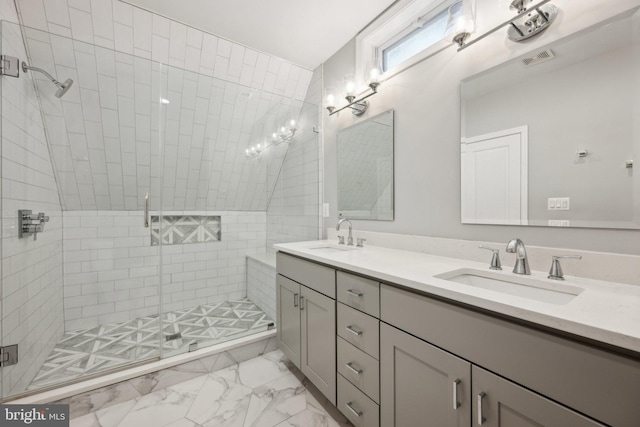 bathroom with lofted ceiling, an enclosed shower, and vanity