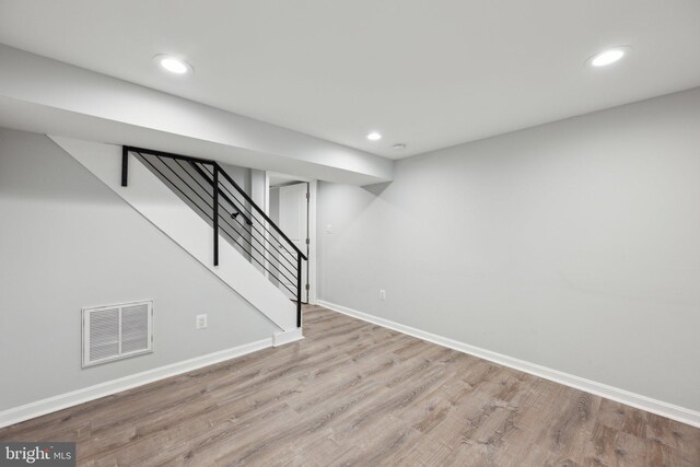 basement with light hardwood / wood-style flooring