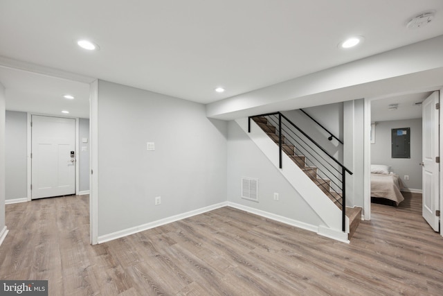 basement with light hardwood / wood-style flooring