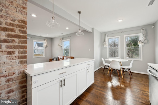 kitchen with hanging light fixtures, white cabinets, dark wood-type flooring, and dishwasher