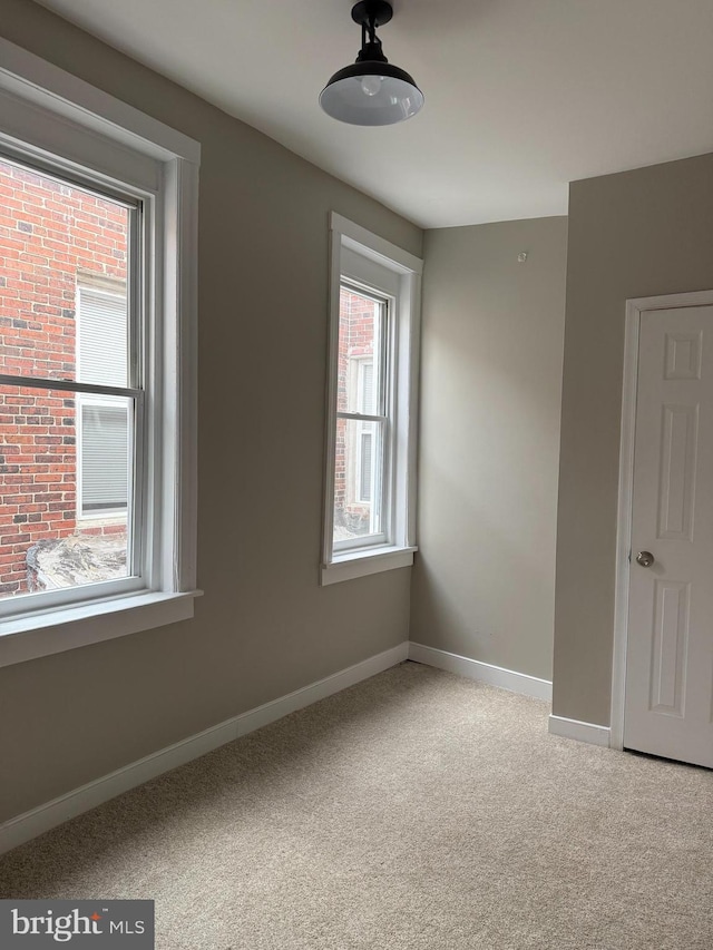 spare room with light carpet