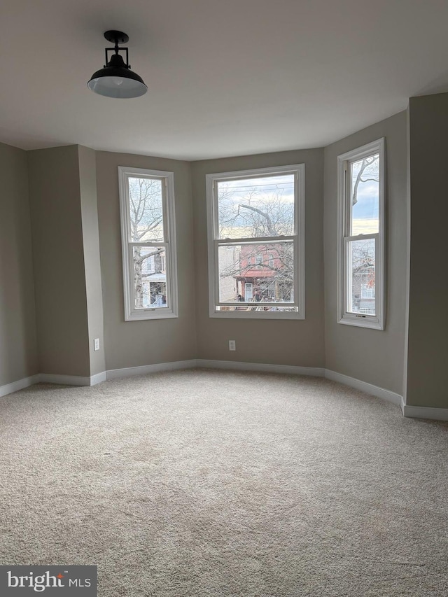 empty room with carpet flooring and plenty of natural light