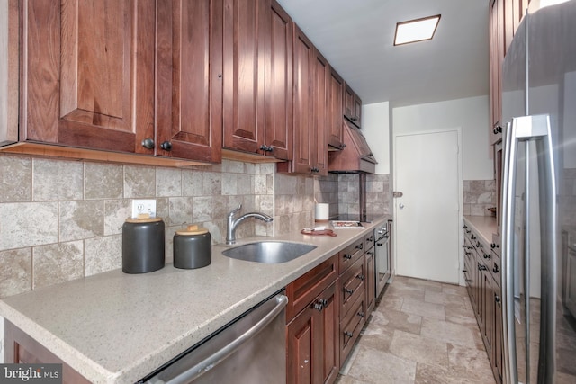 kitchen with sink, stainless steel appliances, and decorative backsplash