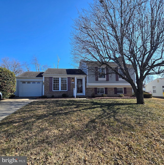 tri-level home with a front yard, brick siding, driveway, and an attached garage