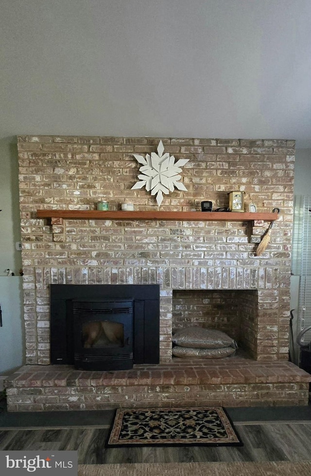 details featuring a fireplace and wood finished floors