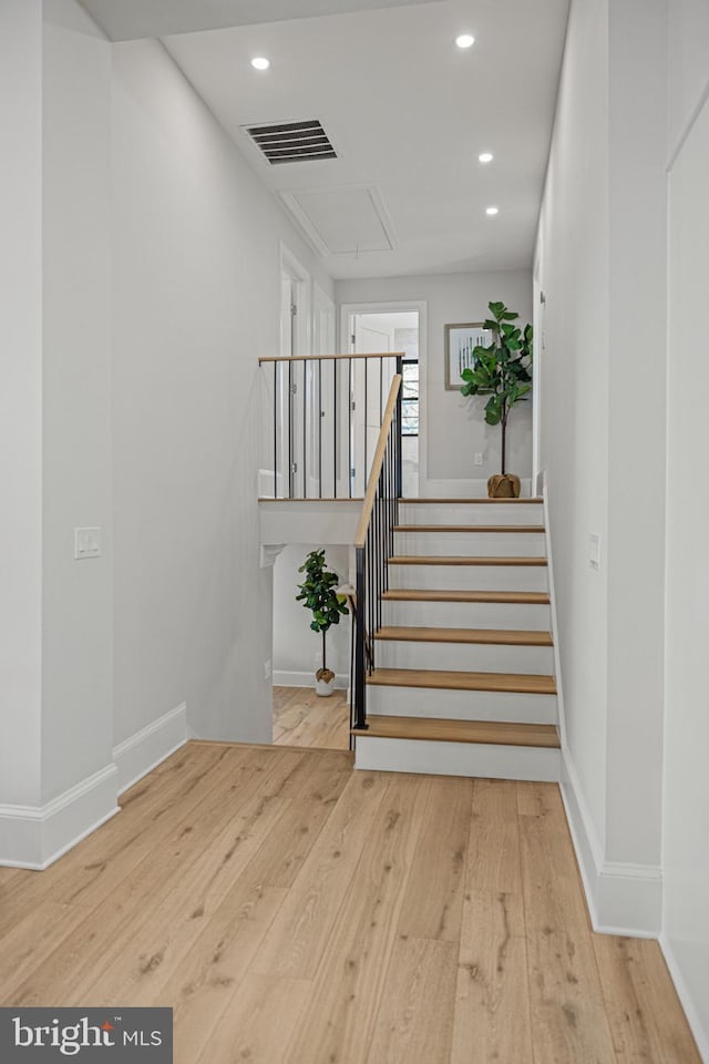 stairway featuring wood-type flooring