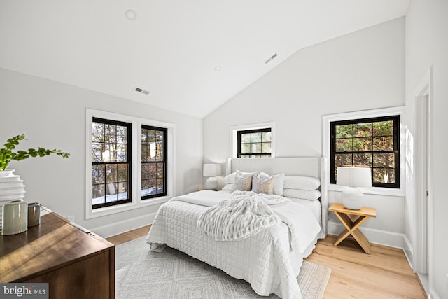 bedroom with lofted ceiling and light hardwood / wood-style flooring