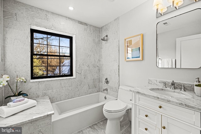 full bathroom with toilet, tiled shower / bath combo, and vanity