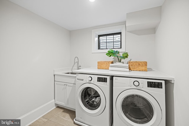 clothes washing area featuring light tile patterned flooring, cabinets, separate washer and dryer, and sink