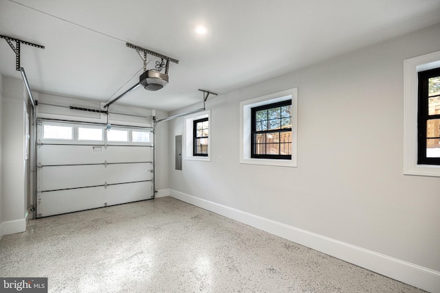 garage with electric panel and a garage door opener