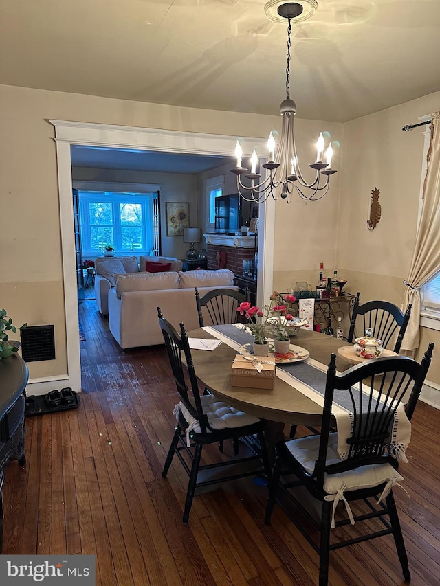 dining space featuring a chandelier and dark wood-type flooring