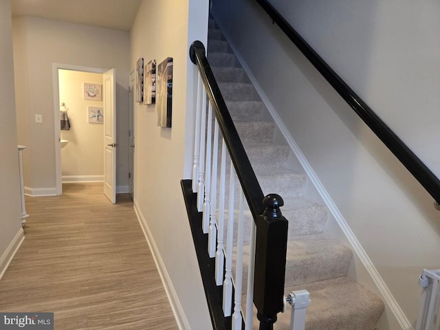 stairway with hardwood / wood-style floors