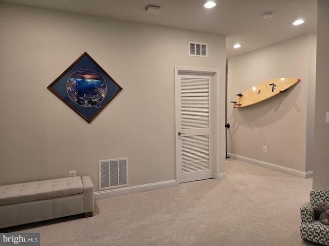 living area with light colored carpet