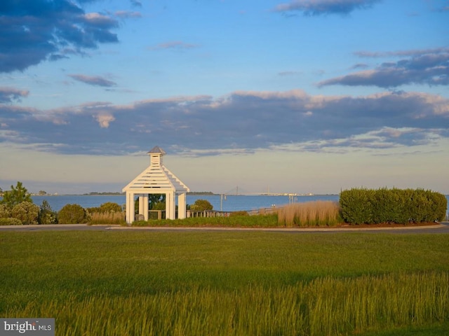 view of home's community featuring a gazebo, a lawn, and a water view