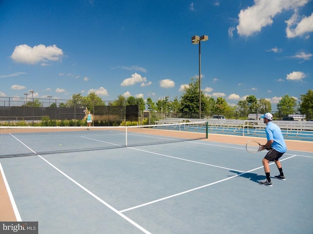 view of tennis court with basketball hoop