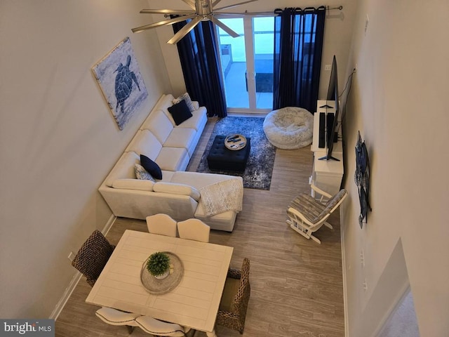 living room featuring ceiling fan and hardwood / wood-style floors