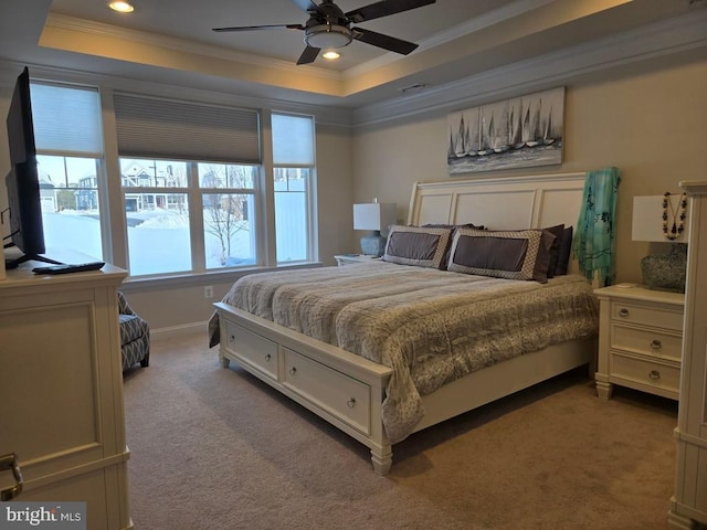 bedroom featuring ornamental molding, carpet flooring, ceiling fan, and a tray ceiling