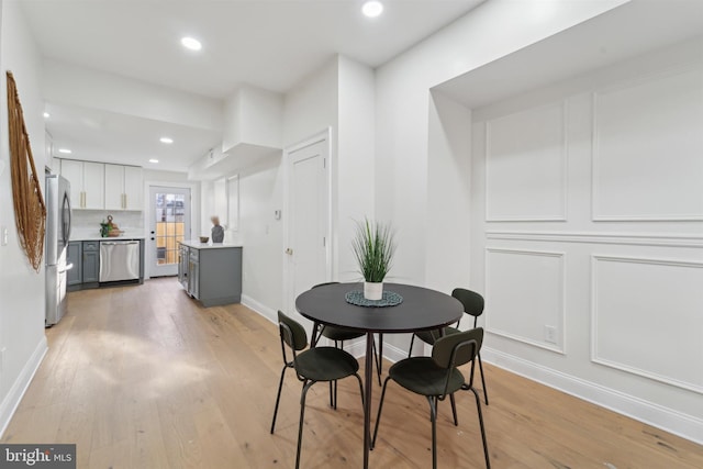 dining area with light hardwood / wood-style flooring