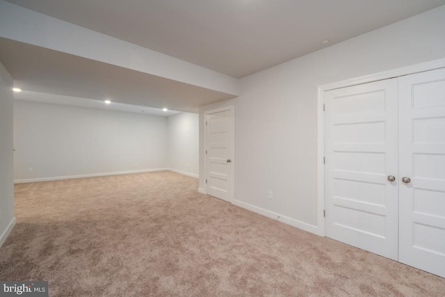 basement featuring light carpet