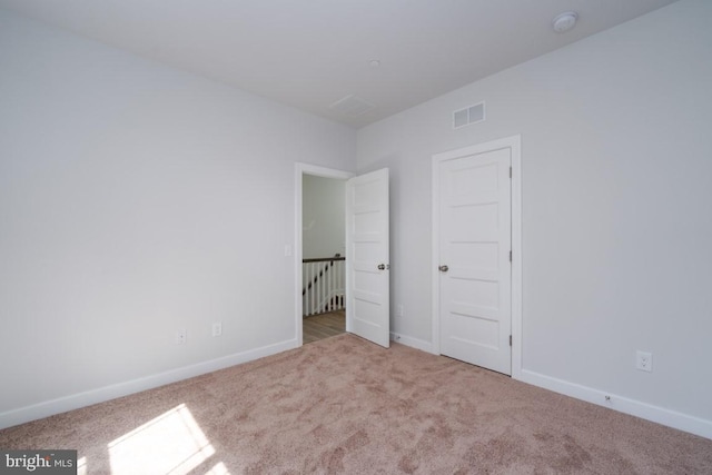 unfurnished bedroom with light carpet