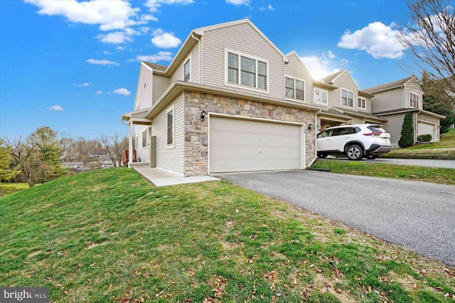 view of front of house featuring a garage and a front lawn