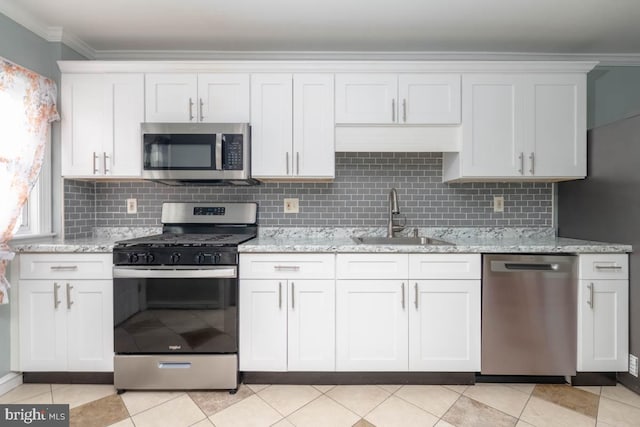 kitchen with sink, crown molding, light stone counters, stainless steel appliances, and white cabinets