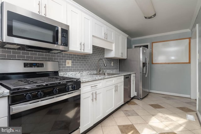 kitchen featuring sink, white cabinetry, backsplash, stainless steel appliances, and light stone counters