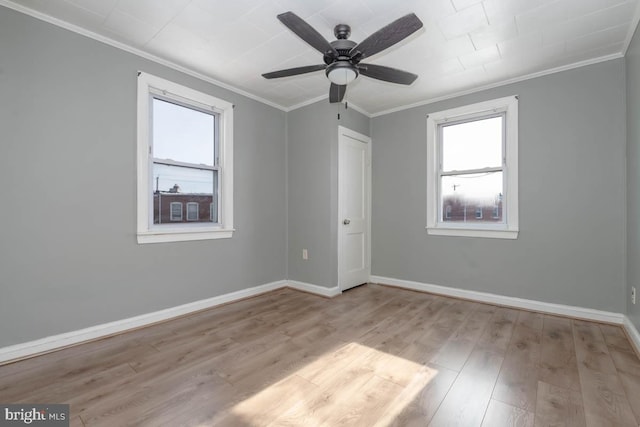 empty room featuring ornamental molding, ceiling fan, and light hardwood / wood-style floors