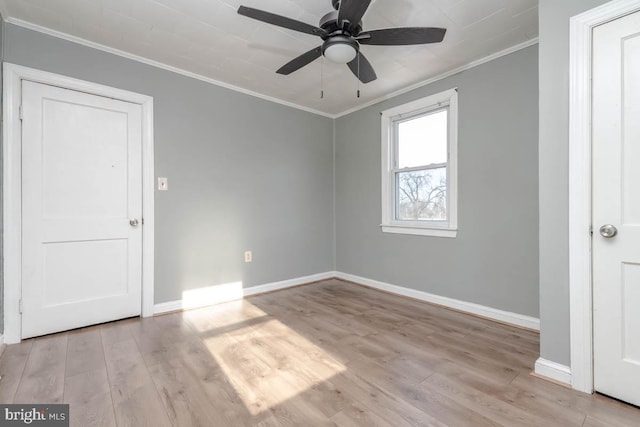 spare room featuring ornamental molding, light hardwood / wood-style floors, and ceiling fan