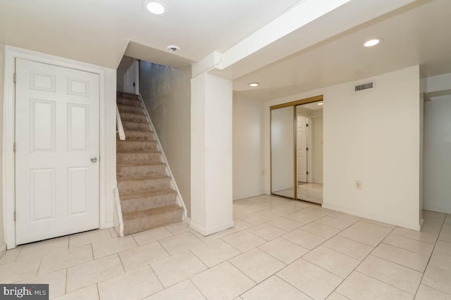 stairway with tile patterned floors