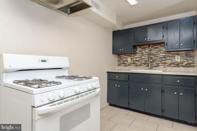 kitchen featuring light tile patterned flooring, white range with gas cooktop, sink, and backsplash