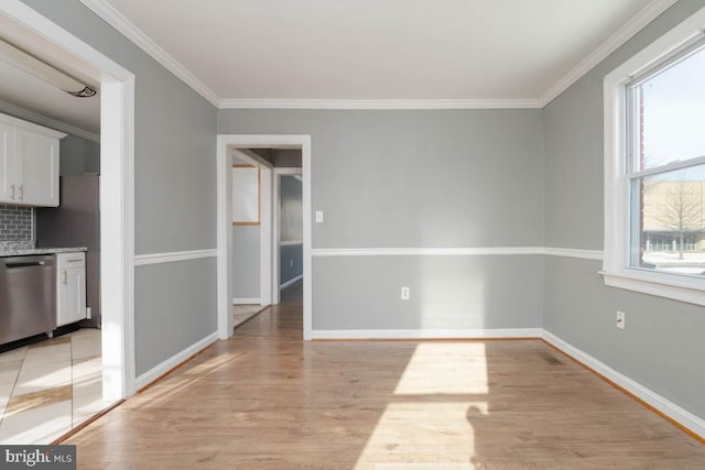 interior space with ornamental molding and light hardwood / wood-style floors