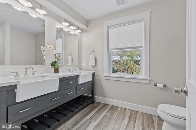 bathroom with toilet, wood-type flooring, and vanity