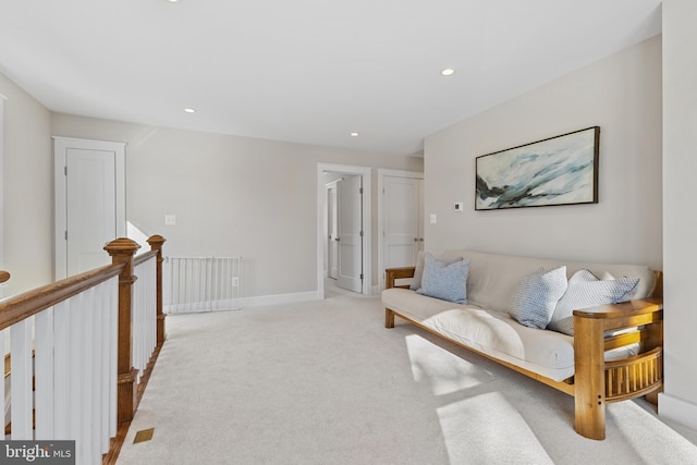 sitting room featuring light carpet